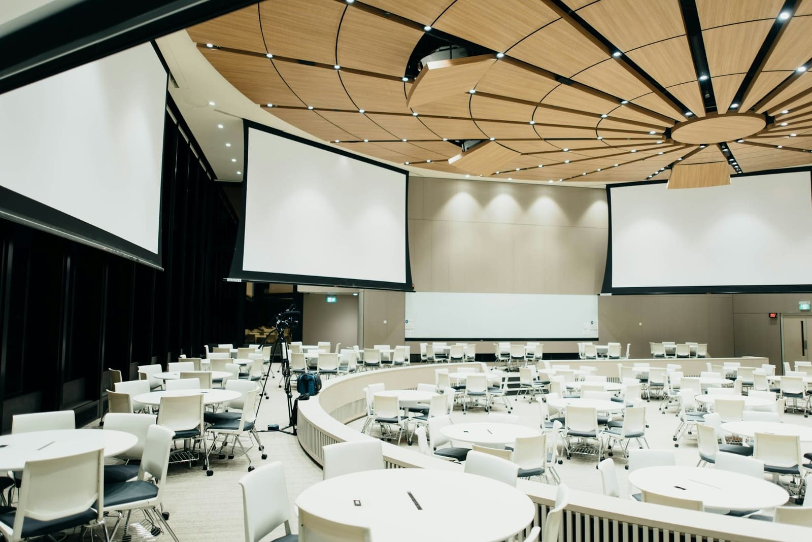 An empty conference hall set with round tables